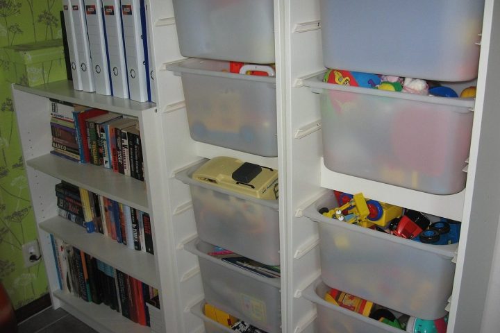 Meuble de rangement avec bacs transparents et étagères de livres